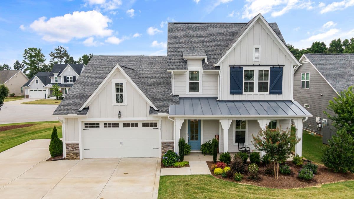 A light-colored family home on a residential street